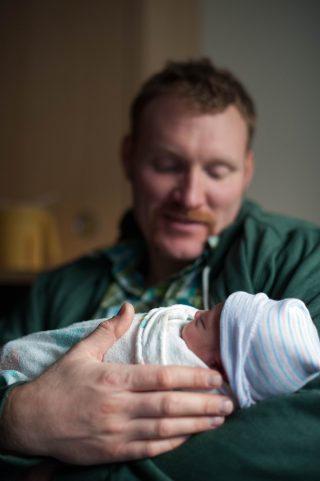 A new dad holds his brand new son at Kaiser Roseville hospital in Roseville, California.