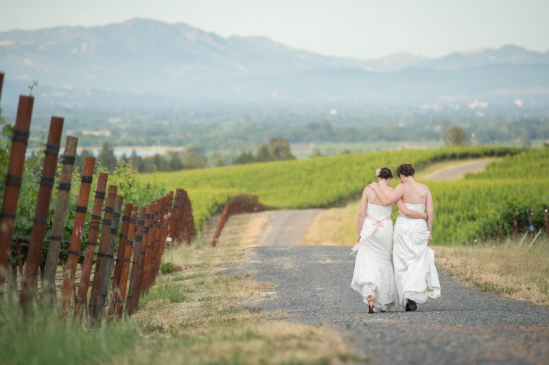 Two lovely ladies walking in the vineyard after their wedding ceremony at Vine Hill House in Sebastopol, California