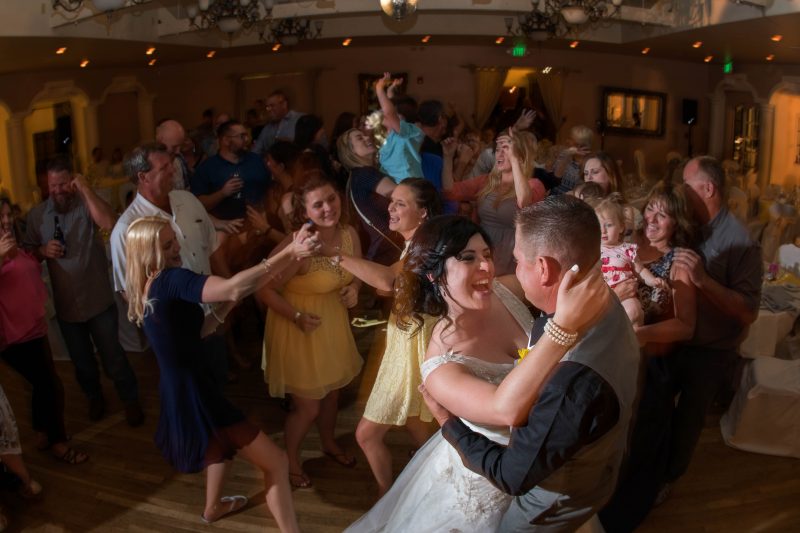 A bride and groom tearing it up on the dance floor during their wedding reception at Sequoia Mansion in Placerville, California
