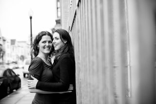 Two newly engaged women hold each other in downtown San Francisco, California.