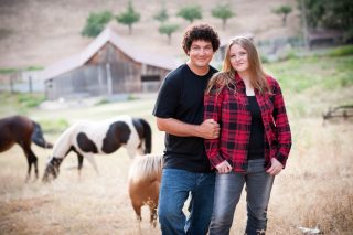 A couple poses for a photo at their Fausel Ranch farm engagement session in Placerville, California.