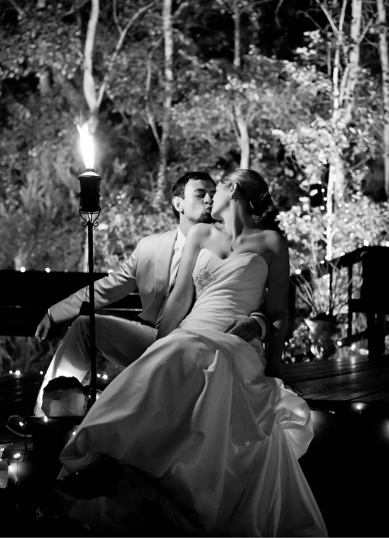 A couple kisses under the light of the moon at High Sierra Iris and Gardens in Camino, CA