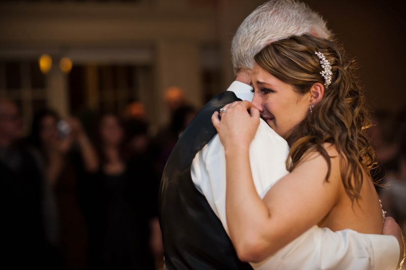 Newlywed bride cries as she dances with her father at her wedding